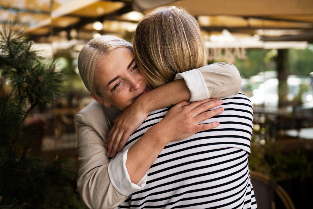 Women hugging and forgiving